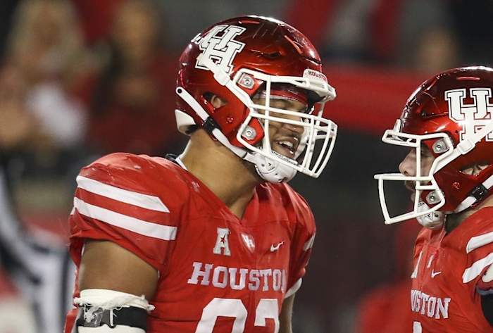 Nov 19, 2021; Houston, Texas, USA; Houston Cougars defensive lineman Logan Hall (92) celebrates defensive lineman Derek Parish (0) sack against Memphis Tigers quarterback Seth Henigan (14) (not pictured) in the fourth quarter at TDECU Stadium. Houston Cougars won 31 to 13. Mandatory Credit: Thomas Shea-USA TODAY Sports